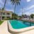 florida-usa-swimming-pool-trees-chairs-urban-landscape-with-blue-sky-reflecting-pool(1)_0x800