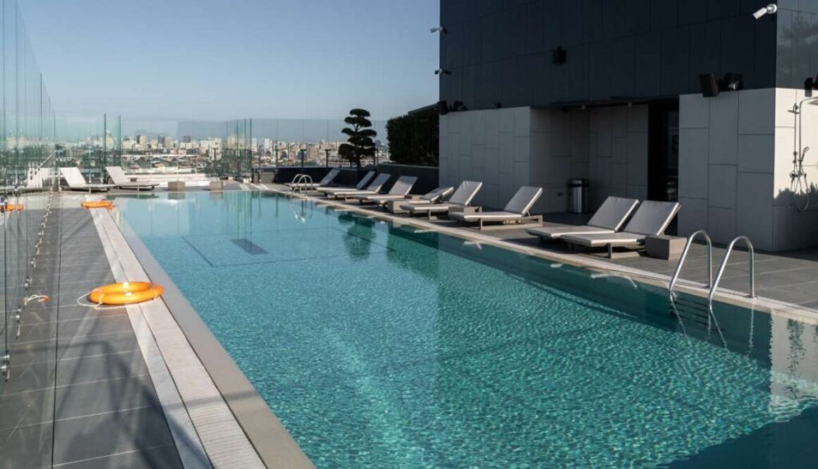 large-modern-pool-with-sunbeds-lifebuoys-concept-recreation_0x800