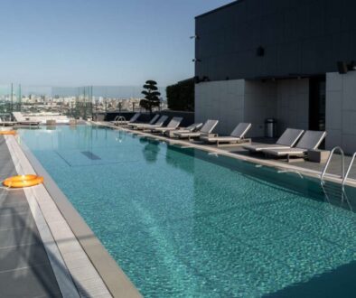 large-modern-pool-with-sunbeds-lifebuoys-concept-recreation_0x800