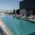 large-modern-pool-with-sunbeds-lifebuoys-concept-recreation_0x800