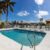 modern-building-with-swimming-pool-trees-chairs-landscape-with-blue-sky-scenic-enviroment(1)_0x800
