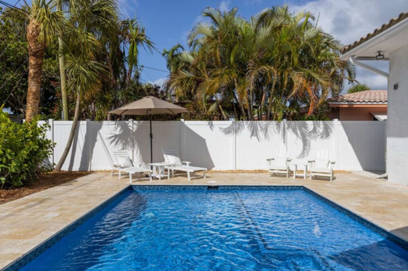 modern-building-with-swimming-pool-trees-chairs-landscape-with-blue-sky-scenic-enviroment(1)_0x800