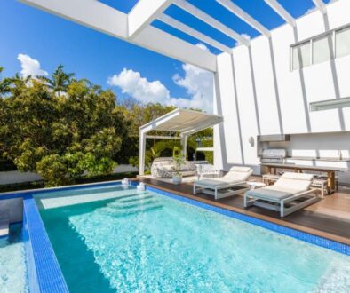 modern-building-with-swimming-pool-trees-chairs-urban-landscape-with-blue-sky-reflecting-pool_0x800