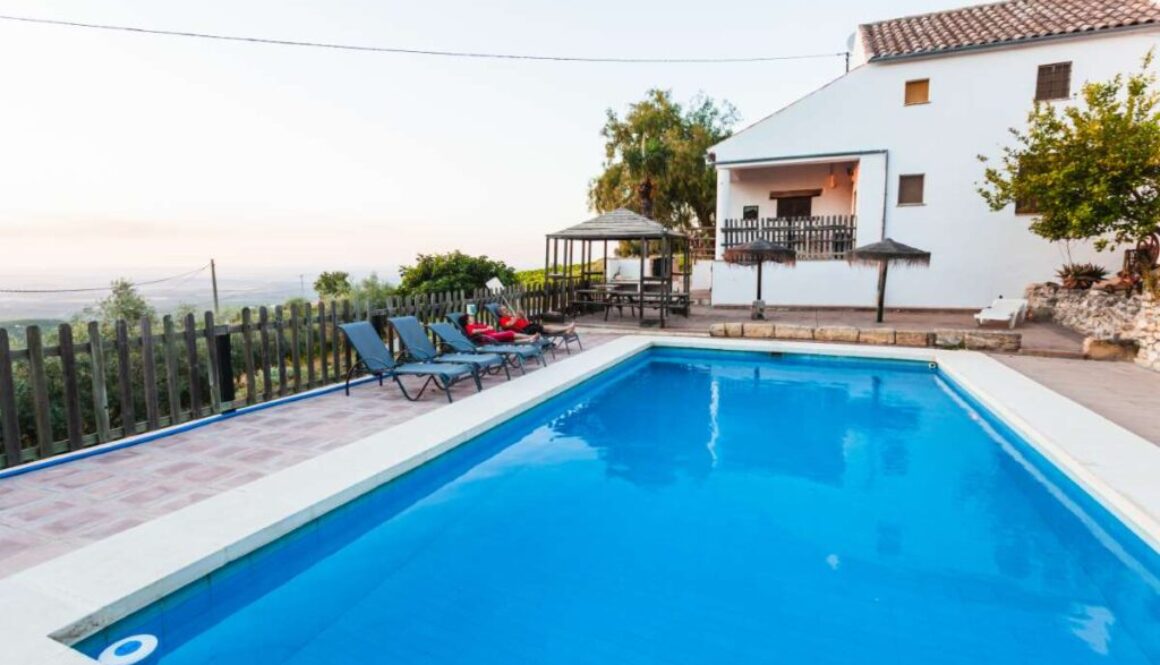 outdoor-pool-with-people-resting-chairs-side-back-villa_0x800