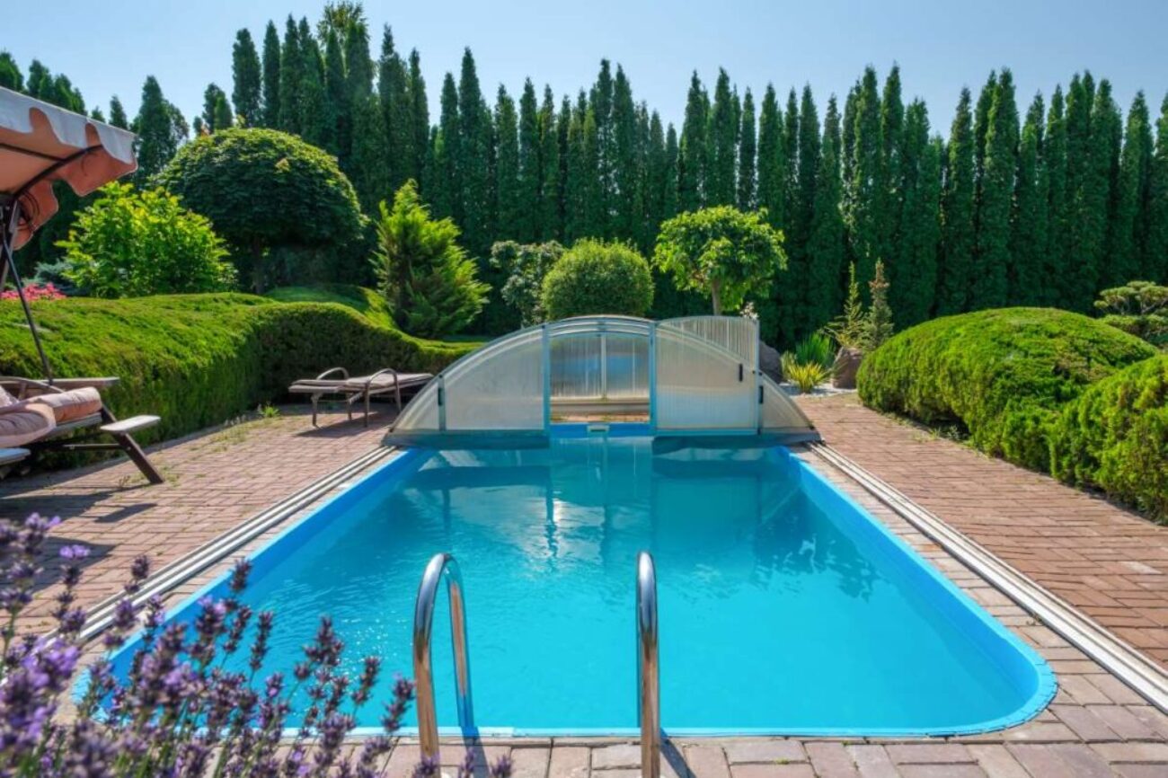 swimming-pool-garden-with-nicely-trimmed-bushes-stones-backyard-landscape-design-high-quality-photo_0x800