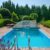 swimming-pool-garden-with-nicely-trimmed-bushes-stones-backyard-landscape-design-high-quality-photo_0x800